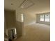 Upstairs loft with hallway entrance, bright windows, and unfinished flooring at 1248 Randwick Valley Ct, Zebulon, NC 27597