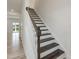 Elegant staircase with wooden steps and white banister at 1248 Randwick Valley Ct, Zebulon, NC 27597