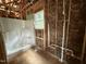 Under-construction bathroom with newly installed shower unit, insulation and plumbing, awaiting finishing touches at 13159 S Nc-231 Hwy, Middlesex, NC 27557