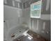 Bathroom under construction, showcasing installed shower and drywall, bathed in natural light at 13159 S Nc-231 Hwy, Middlesex, NC 27557