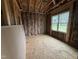 Bedroom under construction features insulation, framing, utility connections, and window awaiting finishing touches at 13159 S Nc-231 Hwy, Middlesex, NC 27557