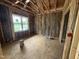 Bedroom framing with installed insulation, utility connections, and window awaiting finishing touches at 13159 S Nc-231 Hwy, Middlesex, NC 27557