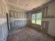 Bright bedroom featuring a window with views, drywall, and an unfinished floor at 13159 S Nc-231 Hwy, Middlesex, NC 27557