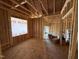 Interior view of the living room framing and trussed roof in new home construction at 13159 S Nc-231 Hwy, Middlesex, NC 27557