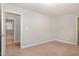 Bright bedroom with neutral walls, carpet, and access to a bathroom and closet for a functional living space at 141 Shad Boat Ln, Clayton, NC 27520
