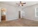 Spacious bedroom with neutral walls, carpet, ceiling fan, and an en-suite bathroom and closet for optimal comfort at 141 Shad Boat Ln, Clayton, NC 27520