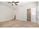 Neutral bedroom featuring carpet, ceiling fan, adjacent bathroom and walk-in closet, providing a comfortable and functional space at 141 Shad Boat Ln, Clayton, NC 27520
