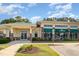 Exterior view of community clubhouse with covered entryway, manicured lawn, and ample parking at 141 Shad Boat Ln, Clayton, NC 27520