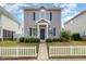 Two-story home with gray siding, black shutters, and a well-manicured front yard with picket fence at 141 Shad Boat Ln, Clayton, NC 27520