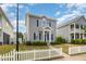 Two-story home with tidy landscaping and charming white picket fence on a sunny day with blue sky at 141 Shad Boat Ln, Clayton, NC 27520