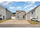 Rear elevation of home with concrete patio that provides ample parking space with room for two cars at 141 Shad Boat Ln, Clayton, NC 27520