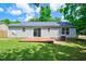 Well-maintained backyard featuring a wood deck, gray vinyl siding, and lush green grass and foliage at 144 Holly Mountain Rd, Holly Springs, NC 27540