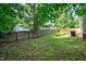 Exterior featuring a grassy yard, mature trees and landscaping, and a tall wooden fence at 144 Holly Mountain Rd, Holly Springs, NC 27540
