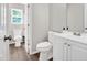 Bathroom featuring a toilet, vanity, and mirror at 144 Holly Mountain Rd, Holly Springs, NC 27540