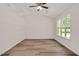 Spacious bedroom with natural light from a window and ceiling fan at 144 Holly Mountain Rd, Holly Springs, NC 27540