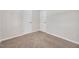 Neutral bedroom with carpeted floor and light gray walls, featuring two white doors and base molding at 144 Holly Mountain Rd, Holly Springs, NC 27540