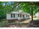 Quaint home with a charming porch, complemented by green landscaping and classic exterior design features at 144 Holly Mountain Rd, Holly Springs, NC 27540