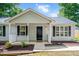 Attractive home exterior showcases a welcoming front porch and classic design elements, framed by tidy landscaping at 144 Holly Mountain Rd, Holly Springs, NC 27540