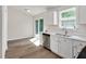 Clean kitchen features white cabinets, stainless appliances, modern countertops, and sliding glass doors at 144 Holly Mountain Rd, Holly Springs, NC 27540