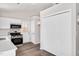 This crisp kitchen boasts stainless steel appliances, sleek quartz counters, white cabinetry, and pantry at 144 Holly Mountain Rd, Holly Springs, NC 27540