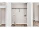 Bright laundry closet featuring white shelving, connections and door, and wood-look vinyl floors at 144 Holly Mountain Rd, Holly Springs, NC 27540