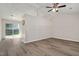 Living room featuring vinyl floors, ceiling fan, and sliding glass doors to the backyard deck at 144 Holly Mountain Rd, Holly Springs, NC 27540