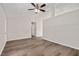 Living room featuring vinyl floors, ceiling fan, and doorway at 144 Holly Mountain Rd, Holly Springs, NC 27540