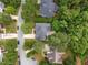 Aerial view of a home with a stone patio, a private backyard surrounded by mature trees in a quiet neighborhood at 15 Aman Ct, Durham, NC 27713
