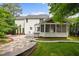 Well-manicured backyard featuring a stone walkway, patio, deck, and screened-in porch at 15 Aman Ct, Durham, NC 27713