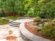 Beautiful backyard waterfall feature with flagstone patio and lush landscaping and retaining walls at 15 Aman Ct, Durham, NC 27713