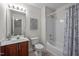 Well-lit bathroom with a shower-tub combo and elegant vanity with updated fixtures at 15 Aman Ct, Durham, NC 27713