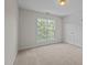 Bright, carpeted bedroom with natural light streaming through the window at 15 Aman Ct, Durham, NC 27713