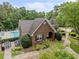 Aerial view of a brick clubhouse with a swimming pool, landscaping and patio furniture at 15 Aman Ct, Durham, NC 27713