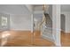 Elegant foyer featuring hardwood floors, staircase with carpet runner, and neutral paint at 15 Aman Ct, Durham, NC 27713