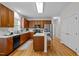 Modern kitchen with dark wood cabinets, stainless steel appliances, and a breakfast bar at 15 Aman Ct, Durham, NC 27713