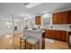 Bright kitchen with island seating, wood cabinets, and open to living space at 15 Aman Ct, Durham, NC 27713