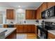 Kitchen featuring wood cabinets, countertops, and a window over the sink at 15 Aman Ct, Durham, NC 27713