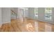 Spacious room with hardwood floors and white trim and a view of the entry at 15 Aman Ct, Durham, NC 27713
