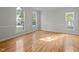Bright living room with hardwood floors, chair rail, and large windows offering ample natural light at 15 Aman Ct, Durham, NC 27713