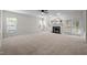 Spacious living room features neutral carpet, a fireplace, and lots of natural light at 15 Aman Ct, Durham, NC 27713
