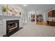 An open-concept room with a fireplace, French doors, and a view of the kitchen at 15 Aman Ct, Durham, NC 27713
