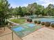 Recreation area with shuffleboard, volleyball and tennis court surrounded by lush landscaping at 15 Aman Ct, Durham, NC 27713