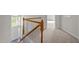 Bright stairway featuring white wood trim and tan carpet, leading to the upper level at 15 Aman Ct, Durham, NC 27713