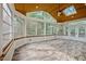 Bright sunroom with multiple windows, a skylight, tile floors, and a ceiling fan at 15 Aman Ct, Durham, NC 27713