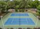 Overhead shot of well maintained tennis courts with lush green trees in the background at 15 Aman Ct, Durham, NC 27713