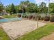 Sandy volleyball court surrounded by manicured lawns and lush landscaping at 15 Aman Ct, Durham, NC 27713