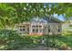 Charming backyard featuring a covered patio, lots of windows, and a well-manicured lawn at 151 Cobble Ridge Dr, Pittsboro, NC 27312