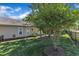 Well maintained backyard with manicured landscaping and a black metal fence with a home in the background at 151 Cobble Ridge Dr, Pittsboro, NC 27312