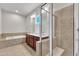 A bathroom with a double vanity, stand up shower and soaking tub at 151 Cobble Ridge Dr, Pittsboro, NC 27312