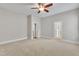 An empty bedroom with carpet, light colored walls and trim, and two entry doors at 151 Cobble Ridge Dr, Pittsboro, NC 27312